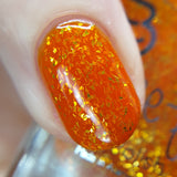 Temporal Essence is an orange jelly base with mini gold metallic flakes