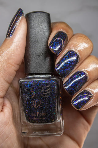 April HHC blue - Lust- Burning Passion  With a black jelly base this polish is full of crystal colour changing flakies and ultra chrome chameleon flakes in shades of blue, some green and gold. With a sprinkling of sapphire holo glitter for added sparkles