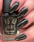 All Hallows’ Evening   A black jelly base with holo flakes and an orange shimmer