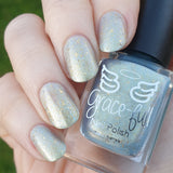 Stop the Rain - with a blue - gold base this polish has light blue aurora shimmer and gold metallic flakes