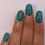 Flight of fancy - a deep green base with reflective holo glitter and three sizes of sea green holo glitter