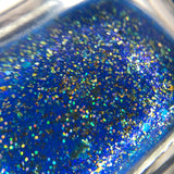 I’ve got Gifts? royal blue base with blue aurora shimmer and UCC flakes in gold-bronze-silver & gold holo micro glitter.